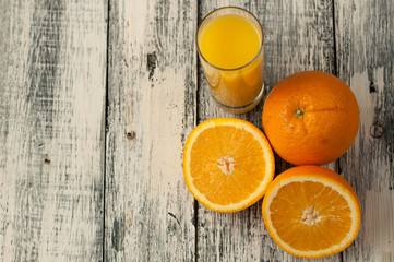 Orange fruit cut and orange juice on wooden table background,