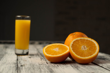 Orange fruit cut and orange juice on wooden table background,
