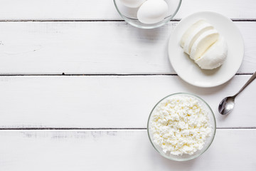 Fresh dairy products on white wood background top view mock-up