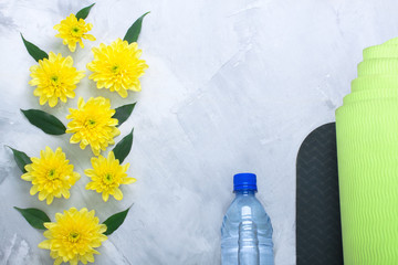 Summer spring flatlay composition yoga mat and bottle of water