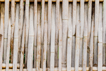 old grungy thai handcraft of bamboo weave pattern fence.
