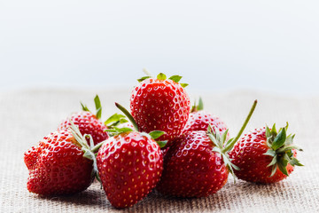 red close up strawberries with selective focus on a strawberry with many strawberries