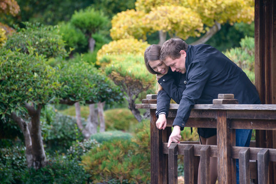 Young Romantic Couple Together Outside On Bridge