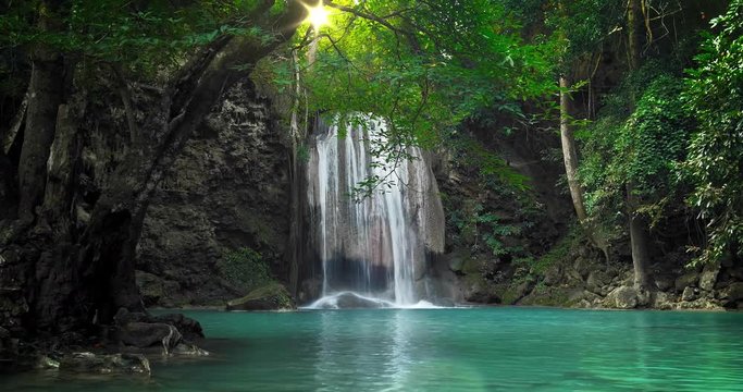 Scenic nature of beautiful waterfall and emerald pool of fresh water lake in wild jungle forest environment in Thailand. Travel and adventure landscape of amazing Asia