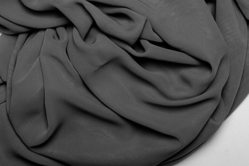 Black and white background texture, satin fabric with folds.