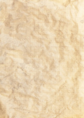 A crumpled old textured worn sheet of paper.
