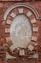 Round frame in the wall of a building made of red brick