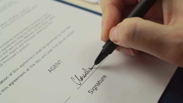 Woman signing sale agreement, close up