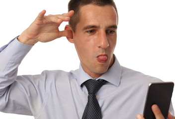 Bad news from bad people. Businessman holding mobile phone, isolated on white background. Pout or disappointed man with smarth, celular phone.
