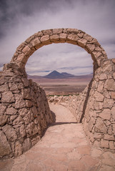 Stone gate at Pukara de Quitor - Inca fortress at Atacama desert with the view at Licancabur...