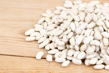 Fototapeta na wymiar Pile of white beans on the wooden table