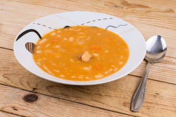 Cooked beans served in the plate on the table