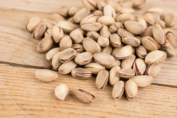 Pile of roasted pistachio on the wooden table