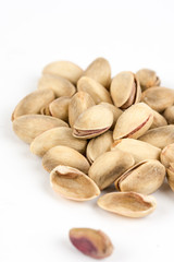 Pile of roasted pistachio over white background