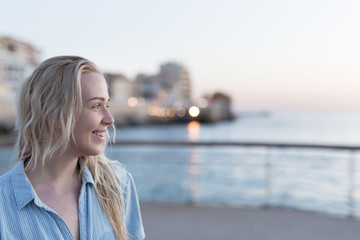 Woman enjoying her free time at the beach in the sunset time. Vacation time. Concept of holiday.