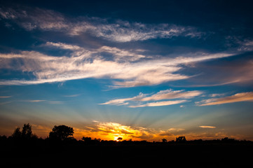 Sun rays in the sky. Sunset scene landscape