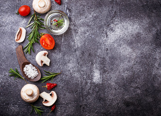 Mushrooms, tomatoes, rosemary, salt and oil. Food background