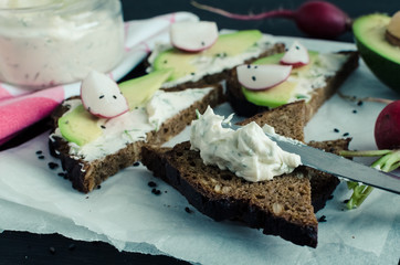 Sandwiches of rye bread with avocado and goat cheese