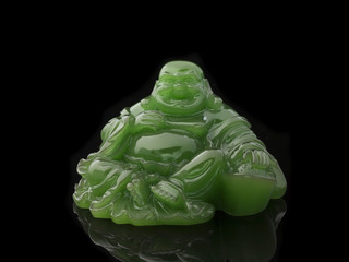 Buddha statue made of green jade on a black background - 142651404