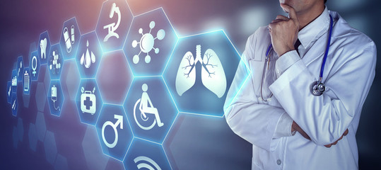 Doctor with stethoscope touching the digital icons