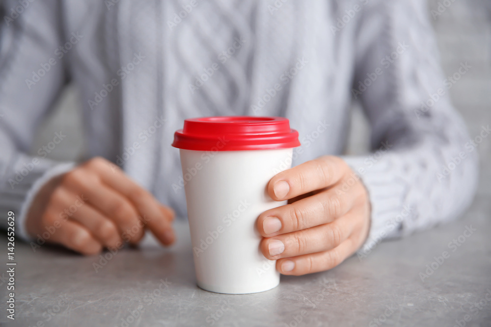 Wall mural Paper cup on grey table