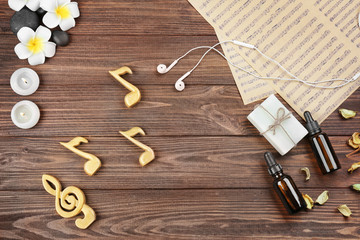 Obraz premium Composition of music sheets and spa supplies on wooden background