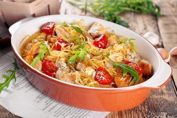 Baking dish with delicious chicken spaghetti on table