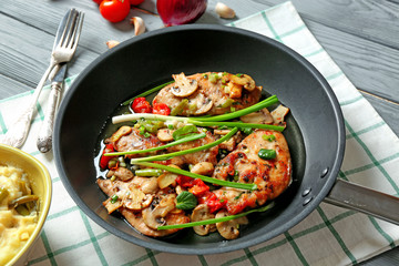 Pan with tasty chicken marsala on table