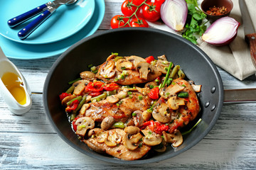 Tasty chicken marsala on pan on table