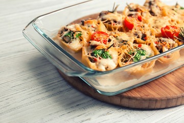 Glass baking dish with stuffed pasta on table