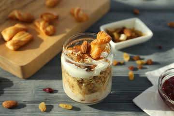 Delicious dessert with banana in jar on table