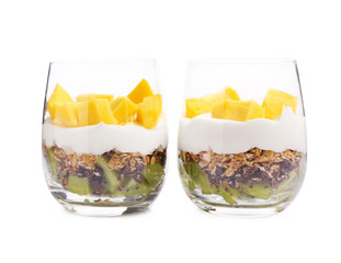 Delicious dessert with mango in glasses on white background