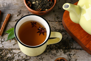 Obraz na płótnie Canvas Cup of aromatic tea on wooden background