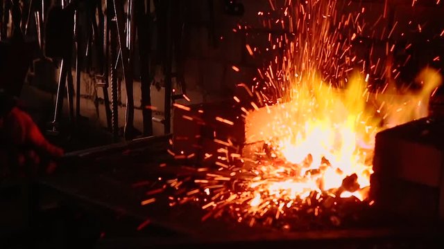 Slow Motion Blacksmith Forging a Sword