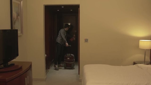Young man with baggage Check in hotel room