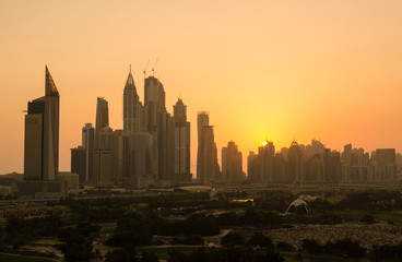 United Arab Emirates, Dubai, 07/02/2015, dubai marina dusty sunset cityscape silhouette at sunset. vibrant orange sky.