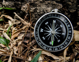 Antique brass compass over wooden background (vintage)