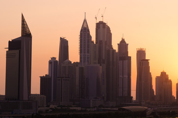 United Arab Emirates, Dubai, 07/02/2015, dubai marina dusty sunset cityscape silhouette at sunset. vibrant orange sky.