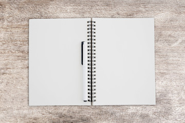 Blank note book on wood texture background.