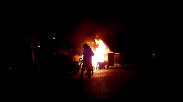 Firefighters suffocating a dumpster