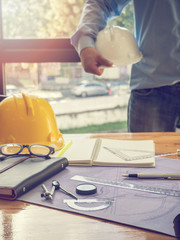 Drafting compass and rulers on blueprints. Architectural concept