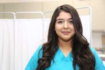 Portrait of a young attractive hispanic healthcare worker. Nurse in medical clinic.