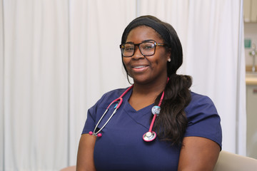 Portrait of a happy African American female healthcare professional, portrait of a nurse with stethoscope