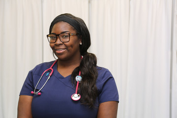 Portrait of a happy African American female healthcare professional, portrait of a nurse with stethoscope - 142663055