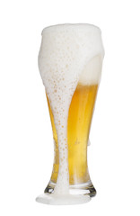 Closeup of  overflowing glass cup of beer. 