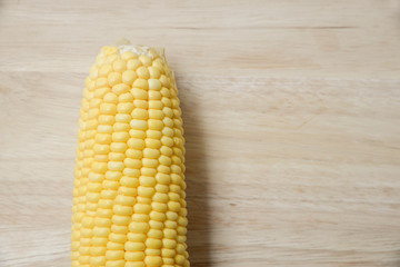Top view of fresh corn on the wood table