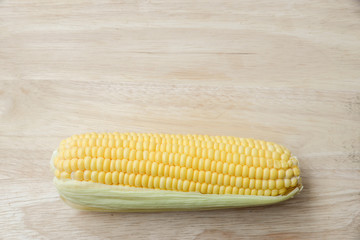 Top view of fresh corn on the wood table