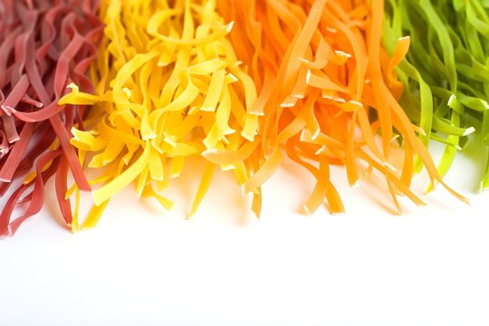 multicolored pasta on a white background. copy space