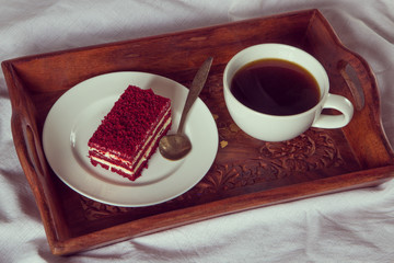 Breakfast in bed. Cup of coffee and red velvet cake