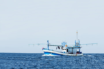 fishing boat in ocean against clear sky.